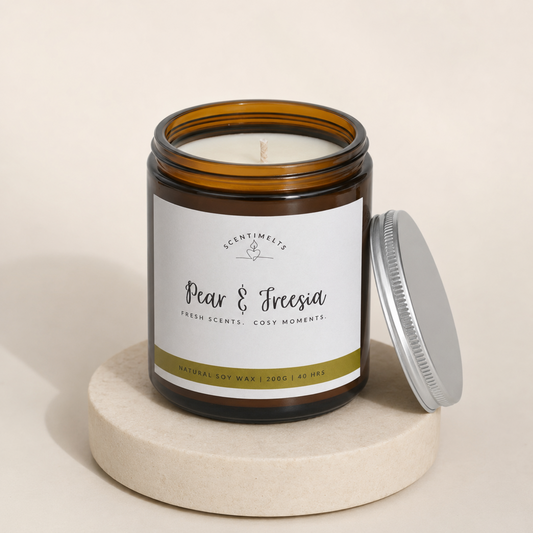 Candle jar labeled 'Pear & Freesia' on a beige background