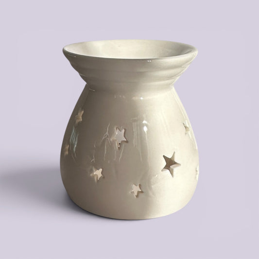 Serene White ceramic tealight burner in cream glaze scattered with small star cut-outs