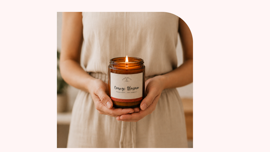 Person holding a Scentimelts Orange Blossom soy candle in an amber jar
